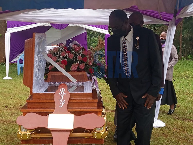 Caroline Kangogo’s father Barnaba Kibor Korir views her body in the casket.